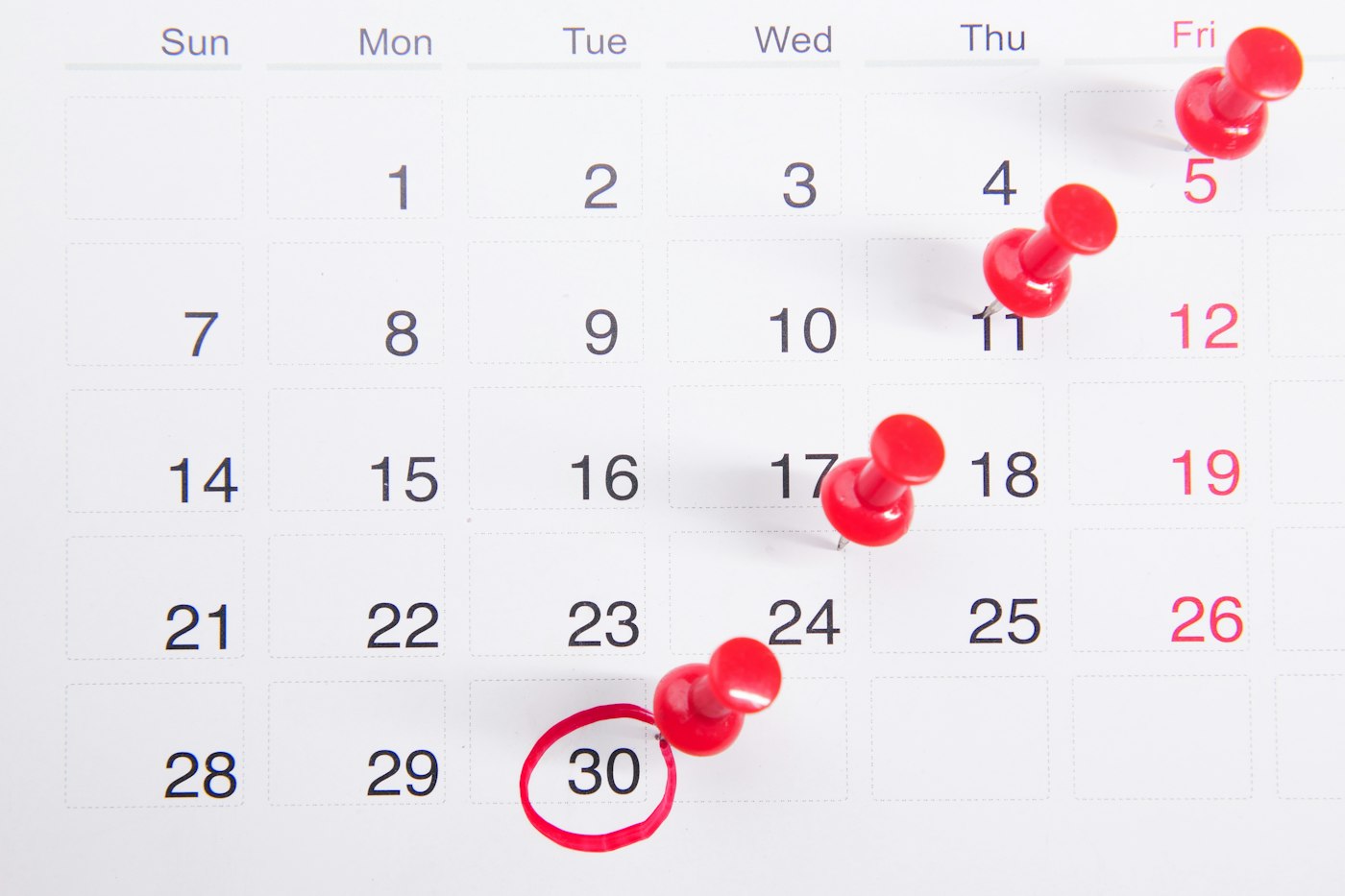 Calendar with red pins marking dates, representing Amazon FBA reimbursement claim deadlines