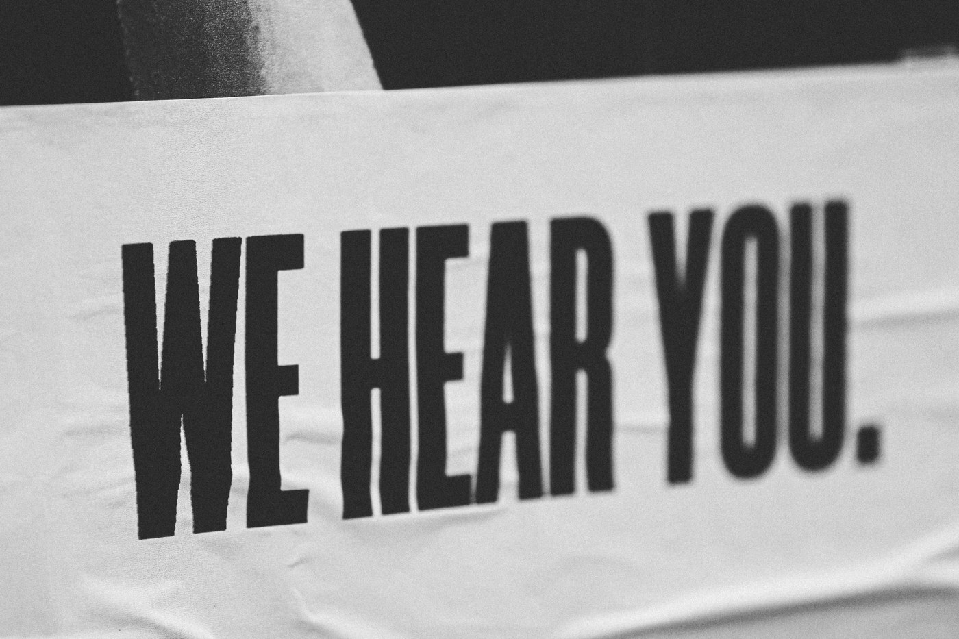 Black and white banner reading We Hear You, representing Amazon Voice of the Customer feedback from shoppers