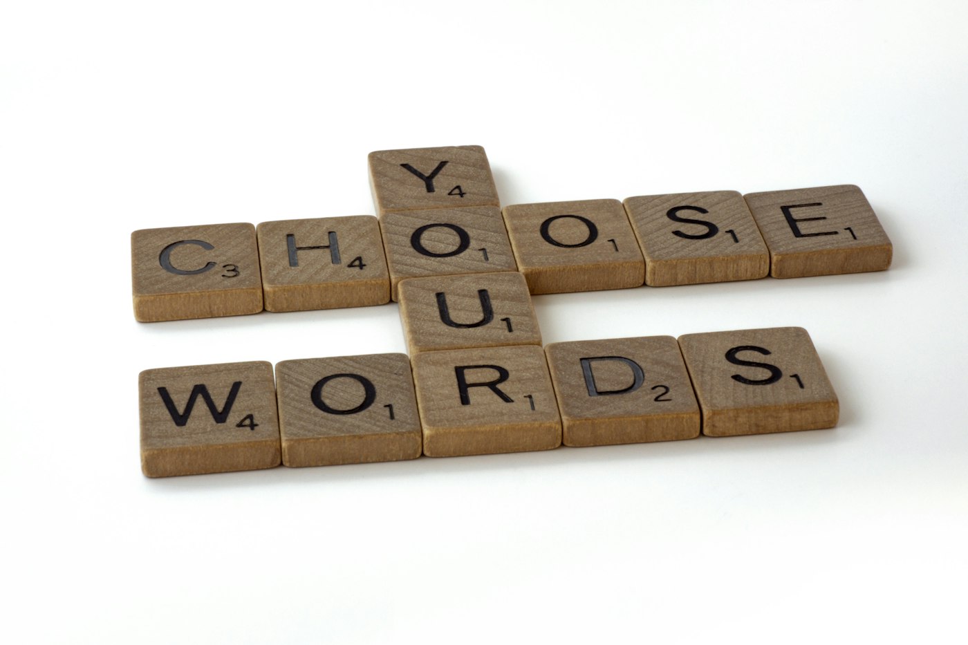 Wooden letter tiles spelling "Choose your words," representing shorter, sharper Amazon product titles
